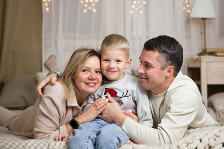 a family sitting on a couch
